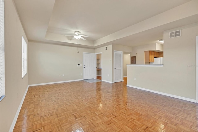 spare room with electric panel, ceiling fan, and light parquet floors