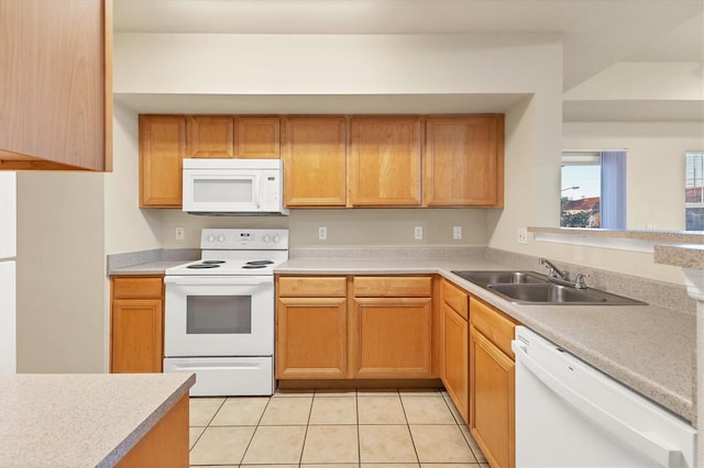 kitchen with light tile patterned flooring, white appliances, and sink