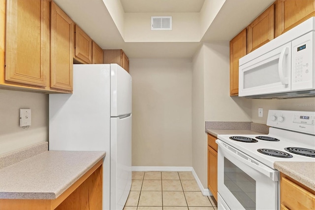 kitchen with light tile patterned floors and white appliances