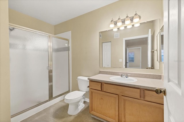 bathroom featuring vanity, toilet, and a shower with shower door