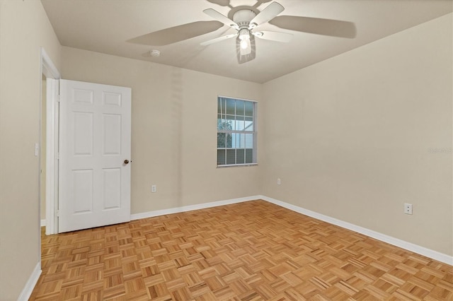 empty room with light parquet floors and ceiling fan