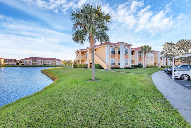 view of front of property with a water view and a front lawn