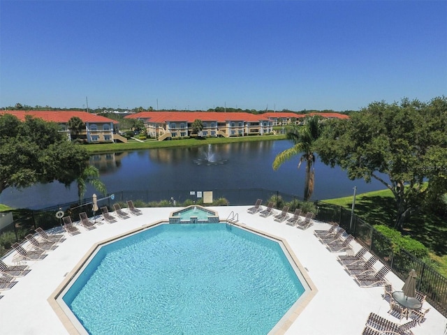 view of pool with a water view and a patio area