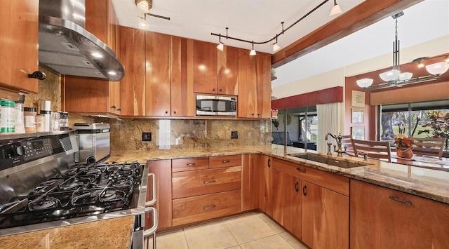 kitchen with sink, light stone counters, ventilation hood, light tile patterned floors, and appliances with stainless steel finishes