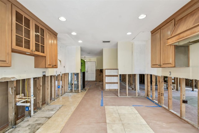 kitchen featuring light tile patterned flooring and custom exhaust hood