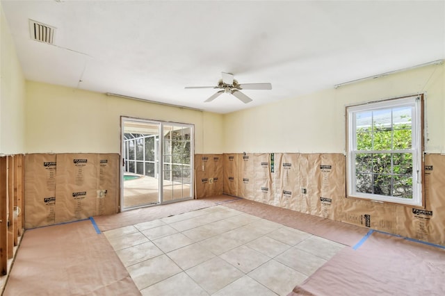 tiled empty room featuring ceiling fan