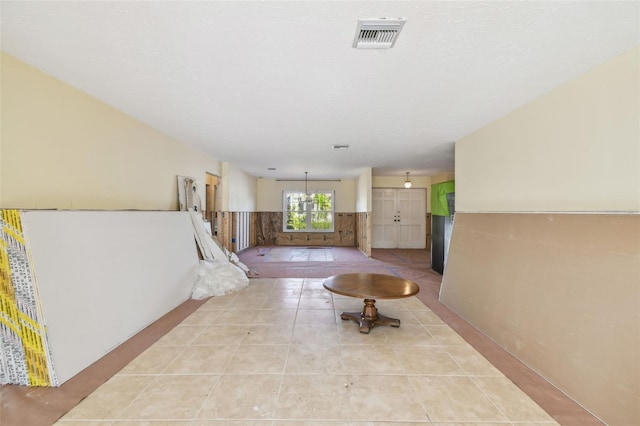 corridor with light tile patterned floors