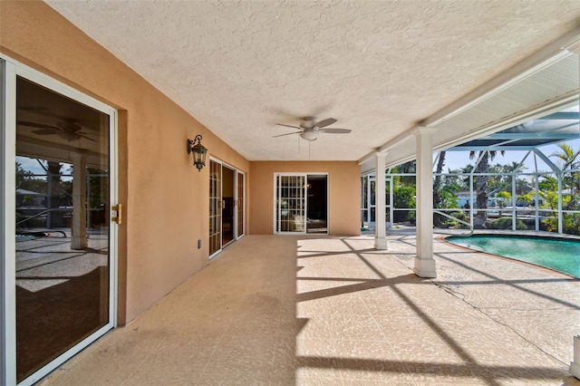 view of patio featuring ceiling fan and a lanai