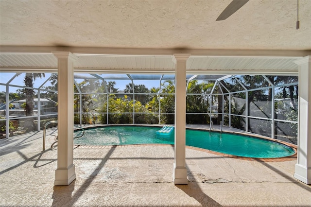 view of swimming pool with a patio area and glass enclosure