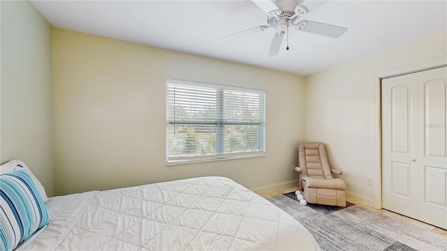 bedroom with ceiling fan and a closet