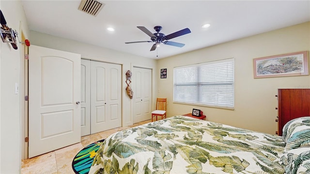 bedroom featuring ceiling fan and two closets