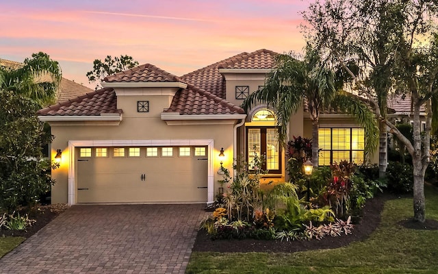 mediterranean / spanish-style house with a garage