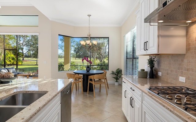 kitchen with white cabinetry, stainless steel appliances, extractor fan, and tasteful backsplash