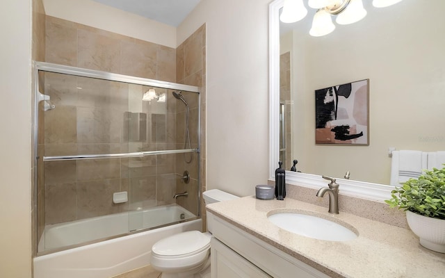 full bathroom with vanity, toilet, and shower / bath combination with glass door