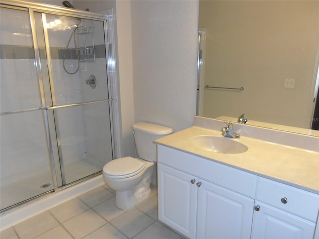 bathroom featuring tile patterned flooring, vanity, and walk in shower