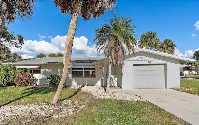 single story home featuring a front yard and a garage