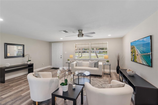 living room featuring ceiling fan and hardwood / wood-style flooring