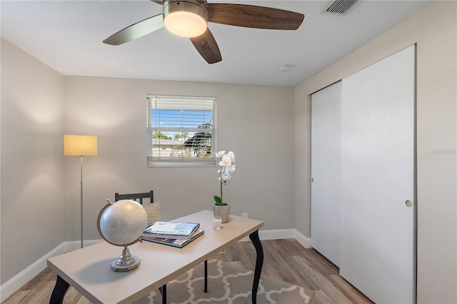 office space with light wood-type flooring and ceiling fan