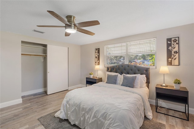 bedroom with hardwood / wood-style floors, a closet, and ceiling fan