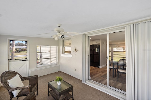 sunroom / solarium featuring ceiling fan