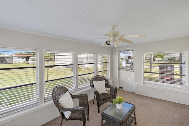 sunroom / solarium featuring plenty of natural light and ceiling fan