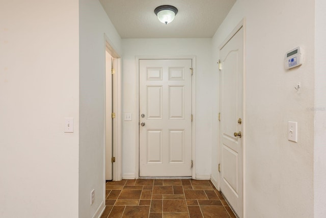 hallway with a textured ceiling