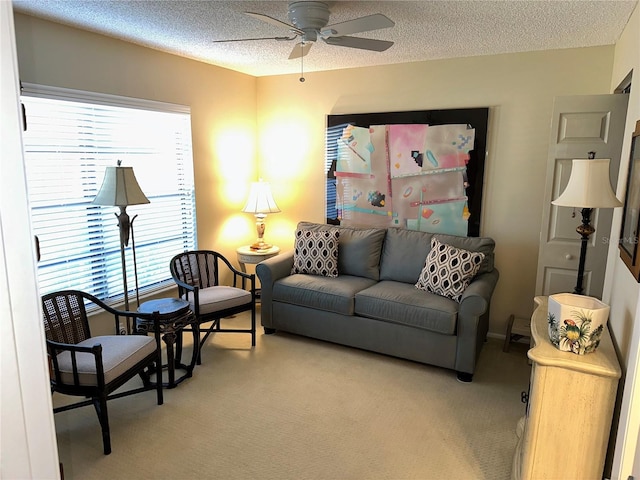 carpeted living room with a textured ceiling and ceiling fan