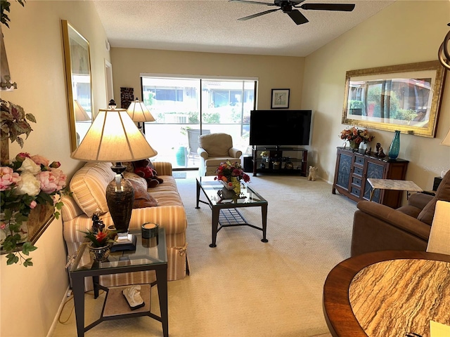 living room with light carpet, a textured ceiling, ceiling fan, and lofted ceiling