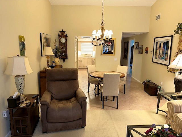 dining space with a high ceiling and a notable chandelier