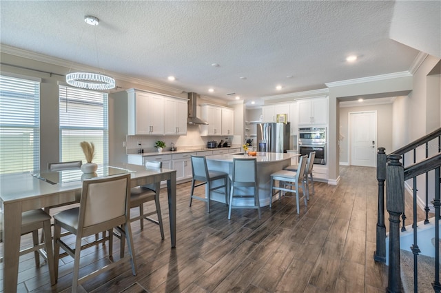 kitchen with white cabinetry, dark hardwood / wood-style floors, crown molding, a textured ceiling, and appliances with stainless steel finishes