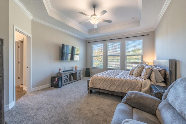 bedroom featuring light carpet, a raised ceiling, ceiling fan, and crown molding