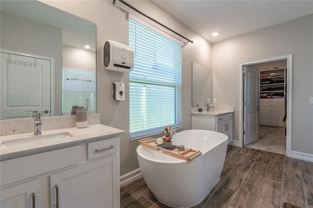 bathroom featuring vanity, wood-type flooring, and plus walk in shower