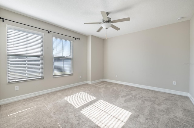 unfurnished room with light carpet and ceiling fan