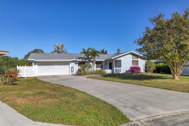 ranch-style home with a front lawn and a garage