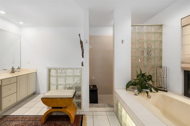 bathroom with tile patterned floors, vanity, and independent shower and bath