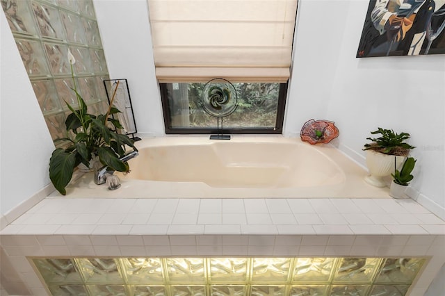 bathroom with a relaxing tiled tub