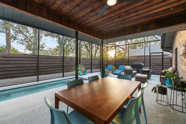 sunroom / solarium featuring ceiling fan and wood ceiling