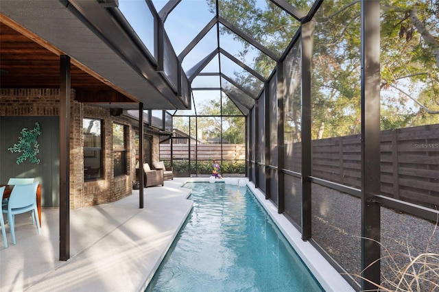 view of pool featuring a lanai and a patio area