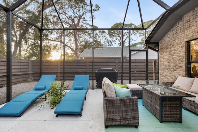 view of patio / terrace with glass enclosure, an outdoor living space, and area for grilling