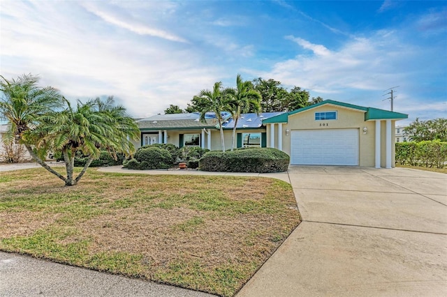 single story home with a garage and a front lawn