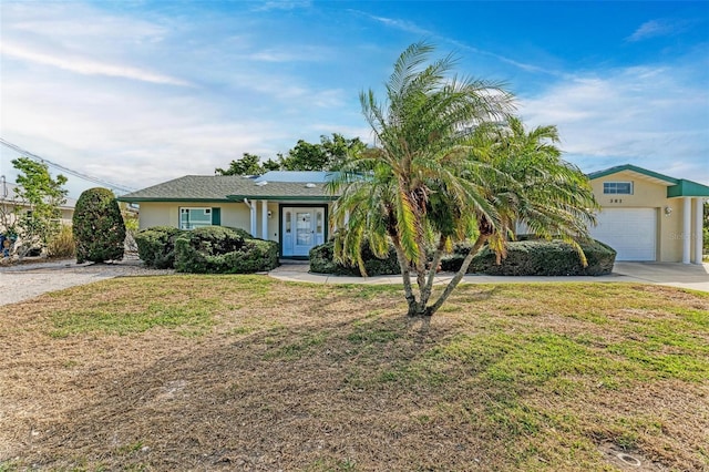 ranch-style home with a front yard and a garage