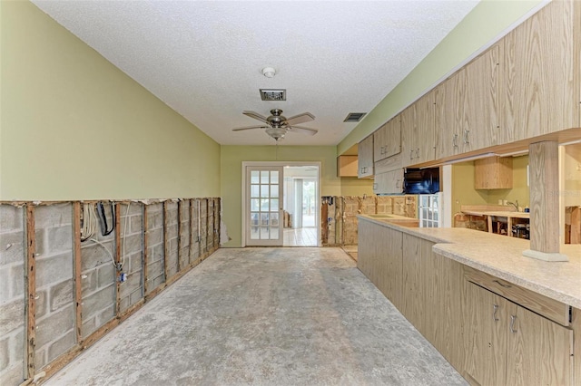 kitchen with light carpet, light brown cabinetry, a textured ceiling, and ceiling fan