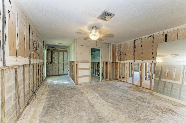 spare room with a textured ceiling and ceiling fan