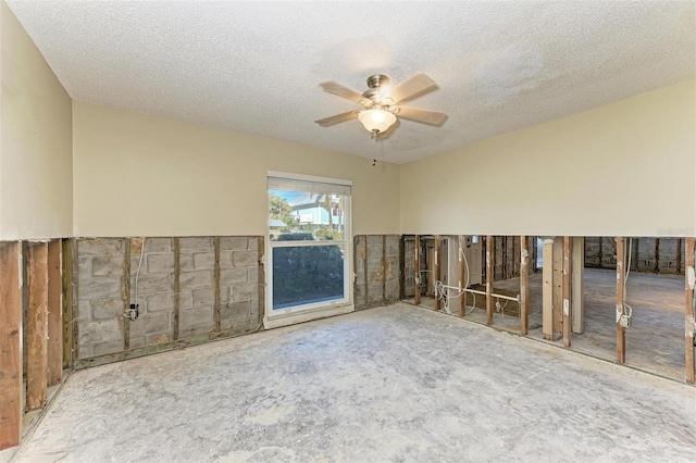 carpeted spare room with a textured ceiling and ceiling fan