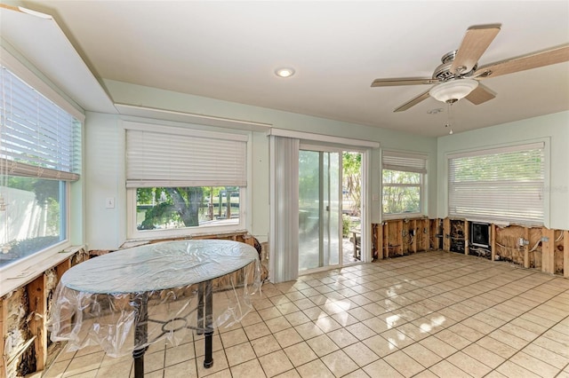 sunroom / solarium featuring ceiling fan