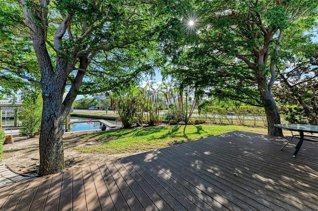 wooden deck with a lawn