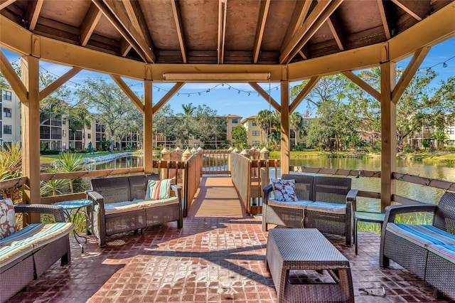 view of patio / terrace with a gazebo, a water view, and outdoor lounge area