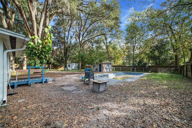 view of yard with a shed and a deck