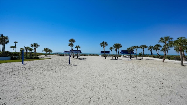 view of community featuring volleyball court and a water view