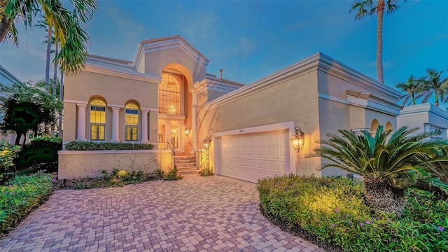 mediterranean / spanish-style house with a garage